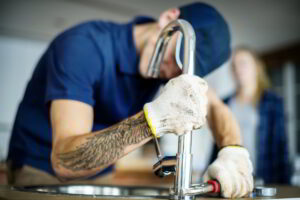 plumber fixing a sink